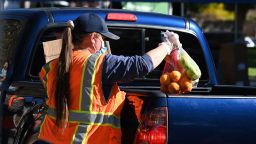 Volunteers load free groceries into cars for people experiencing food insecurity due to the coronavirus pandemic, December 1, 2020 in Los Angeles, California. - As of November 2020, food distribution by the Los Angeles Regional Food Bank has increased by 145% compared to the pre-pandemic levels. (Photo by Robyn Beck / AFP) (Photo by ROBYN BECK/AFP via Getty Images)