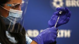 FORT LAUDERDALE, FLORIDA - DECEMBER 17:  Kristina Castro, Nurse Practitioner at Broward Health Medical Center prepares a Pfizer-BioNtech COVID-19 vaccine on December 17, 2020 in Fort Lauderdale, Florida.  Broward Health Medical Center began the vaccination of frontline healthcare workers joining with hospital systems around the country as the COVID-19 vaccine is rolled out. (Photo by Joe Raedle/Getty Images)