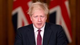 Britain's Prime Minister Boris Johnson speaks during a news conference in response to the ongoing situation with the coronavirus (COVID-19) pandemic, inside 10 Downing Street, London, Saturday, Dec. 19, 2020. Johnson says Christmas gatherings can't go ahead and non-essential shops must close in London and much of southern England as he imposed a new, higher level of coronavirus restrictions to curb rapidly spreading infections. 